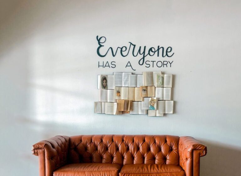 everyone has a story sign with orange chair